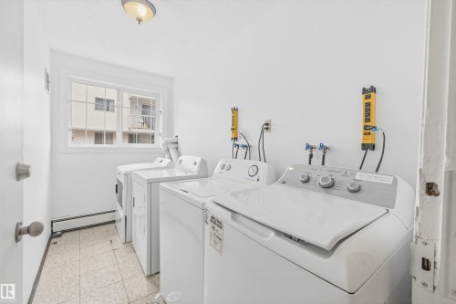Dedicated laundry area featuring a window, tile flooring, and multiple appliance hookups - #8 10931 83 St Nw, Edmonton, AB - Indoor Photo Showing Laundry Room