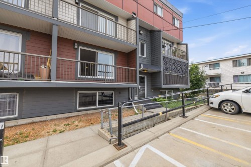 Multi-story building exterior featuring a modern design with balconies and a ground-level entrance ramp - #8 10931 83 St Nw, Edmonton, AB - Outdoor With Balcony