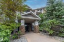 Building entrance featuring a covered portico, stone veneer accents, and numerical street addressing - #6201 7331 South Terwillegar Dr Nw, Edmonton, AB  - Outdoor 
