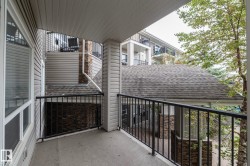 Private balcony featuring concrete flooring and black metal railings - 