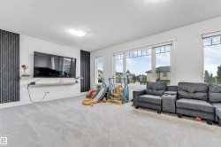 Spacious room featuring light-colored carpeting and white walls - 