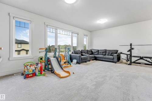Spacious room featuring light-colored carpeting, multiple large windows, and recessed lighting - 6727 20 Ave Sw, Edmonton, AB - Indoor