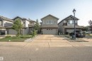 Two-story residential architecture featuring a gray siding exterior with stone accenting, a concrete driveway, and an integrated single-car garage - 6727 20 Ave Sw, Edmonton, AB  - Outdoor With Facade 