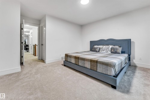 Neutral wall color, light-toned carpeting, white baseboards, and a recessed ceiling light fixture - 6727 20 Ave Sw, Edmonton, AB - Indoor Photo Showing Bedroom