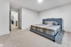 Neutral wall color, light-toned carpeting, white baseboards, and a recessed ceiling light fixture - 