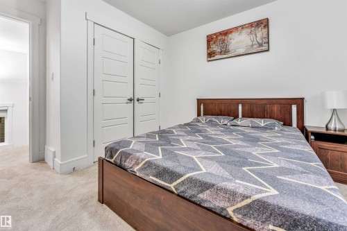 Plush carpet flooring, ample natural light, and clean white walls characterize this room - 6727 20 Ave Sw, Edmonton, AB - Indoor Photo Showing Bedroom