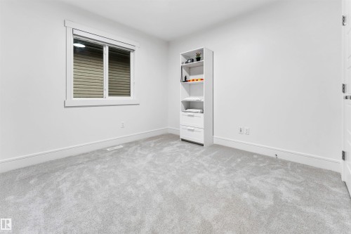 Neutral-toned carpeting paired with crisp white walls - 6727 20 Ave Sw, Edmonton, AB - Indoor