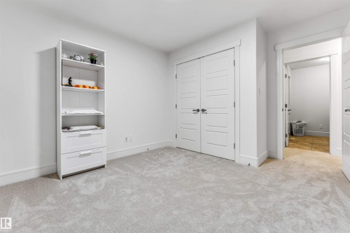 Wall-to-wall light gray carpeting, white baseboards, and bright white walls define this interior space - 6727 20 Ave Sw, Edmonton, AB - Indoor
