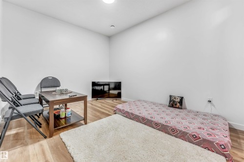 Bright interior space featuring light wood-finish flooring and white walls - 6727 20 Ave Sw, Edmonton, AB - Indoor Photo Showing Bedroom