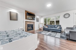 Spacious interior featuring wood-finish flooring and white walls - 
