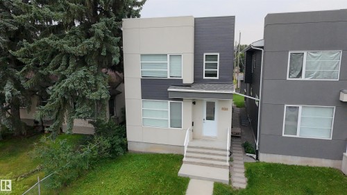 Contemporary facade featuring light and dark gray siding - 9311 66 Avenue Nw, Edmonton, AB - Outdoor