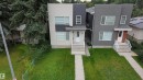 Modern multi-level exterior with a split facade in light and dark gray tones, white entry door, multiple windows, concrete steps, and a compact front lawn - 9311 66 Avenue Nw, Edmonton, AB  - Outdoor With Facade 