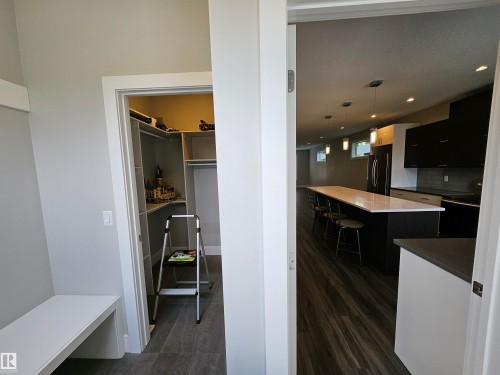 Custom closet organization system and built-in bench seating - 9311 66 Avenue Nw, Edmonton, AB - Indoor Photo Showing Other Room