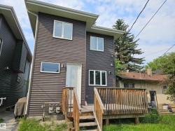 Modern exterior featuring dark horizontal siding and white window frames - 