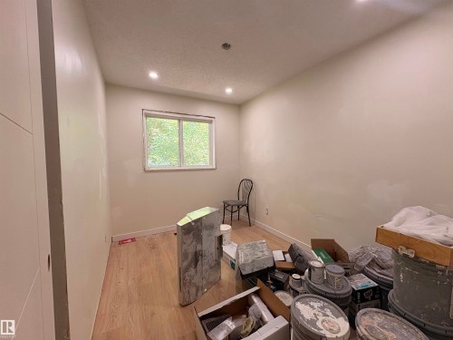 Light-filled room featuring wood-finish flooring, recessed ceiling lighting, and a window with exterior tree scenery - 18007 73 Avenue Nw, Edmonton, AB - Indoor Photo Showing Other Room