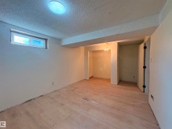 Spacious room with light wood-finish flooring, a recessed window, and neutral wall tones - 