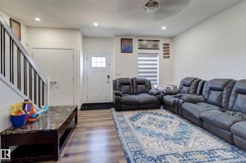 Open concept living area featuring wood-finish flooring and recessed lighting - #8 1703 16 Av Nw Nw, Edmonton, AB - Indoor Photo Showing Living Room