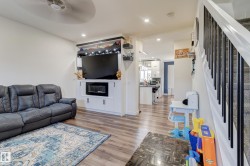 Open-concept living space with wood-finish flooring - 