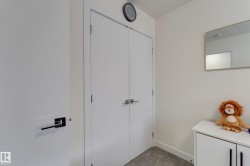Modern interior featuring a double-door closet with contemporary hardware - 