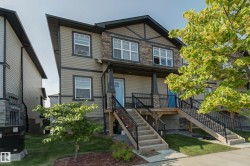 Contemporary exterior featuring a combination of horizontal siding and stone veneer accents - 