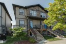 Contemporary exterior featuring a combination of horizontal siding and stone veneer accents - #8 1703 16 Av Nw Nw, Edmonton, AB  - Outdoor 