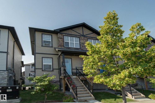 Contemporary two-story exterior with a covered front porch and stone accents - #8 1703 16 Av Nw Nw, Edmonton, AB - Outdoor