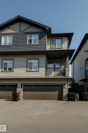 Multi-level residence featuring a multi-tone facade with dark siding and light horizontal siding - 
