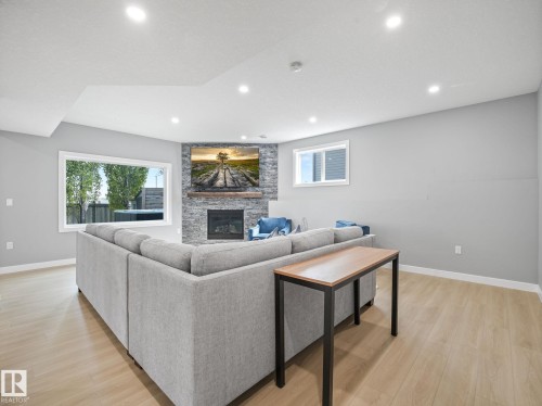 4115 58 Street, Beaumont, AB - Indoor Photo Showing Living Room With Fireplace