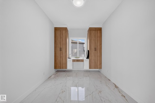 Bright room featuring light-toned walls and large format marble-look tile flooring - 112 Ross Close, Leduc, AB - Indoor Photo Showing Other Room