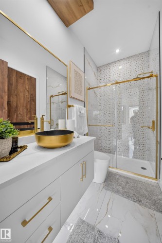 Bathroom featuring a gold vessel sink, white cabinetry with gold hardware, and a walk-in shower with a glass enclosure - 112 Ross Close, Leduc, AB - Indoor Photo Showing Bathroom