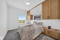 Integrated wood-finish cabinetry and overhead storage define this bedroom space - 