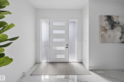 Contemporary entry door with frosted glass panels and sidelights, complemented by polished marble-look flooring - 112 Ross Close, Leduc, AB - Indoor Photo Showing Other Room