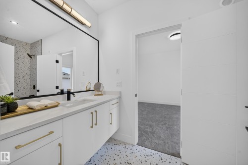 Floating dual vanity with a white countertop, undermount sinks, and matte black faucets - 112 Ross Close, Leduc, AB - Indoor Photo Showing Bathroom