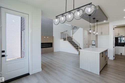 Open concept living space featuring light wood-finish flooring - 8728 182 Avenue Nw, Edmonton, AB - Indoor Photo Showing Kitchen