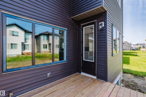 Exterior deck featuring wood planks and siding - 8728 182 Avenue Nw, Edmonton, AB - Outdoor