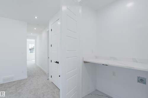 Dedicated built-in desk area with a light-toned countertop - 8728 182 Avenue Nw, Edmonton, AB - Indoor Photo Showing Other Room