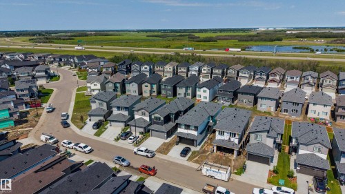 Expansive residential development featuring modern two-story homes with attached garages, paved driveways, and manicured lawns - 8728 182 Avenue Nw, Edmonton, AB - Outdoor With View