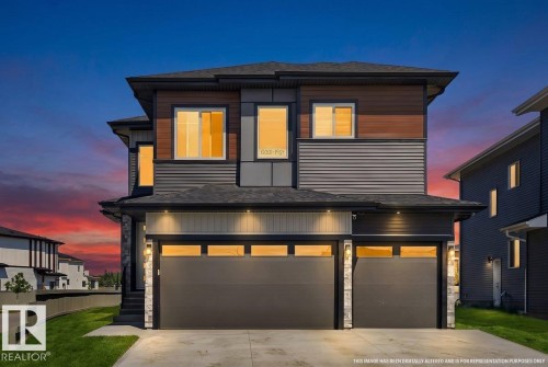 Contemporary multi-level residence featuring a dark gray and wood-finish facade - 6001 19 Street, Nisku, AB - Outdoor