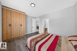 Built-in wood-finish wardrobe with contemporary black handles - 