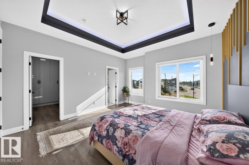 Tray ceiling with recessed lighting and contemporary fixture - 6001 19 Street, Nisku, AB - Indoor Photo Showing Bedroom