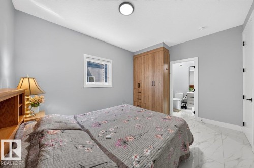 Room featuring light gray walls, white baseboards, and white tile flooring - 6001 19 Street, Nisku, AB - Indoor Photo Showing Bedroom