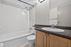 Bathroom featuring a tub/shower combination with white subway tile surround - 