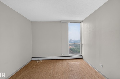 Hardwood-look flooring complemented by light gray wall paint - #1508 10883 Saskatchewan Dr Nw Nw, Edmonton, AB - Indoor Photo Showing Other Room