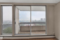 Sliding glass door balcony access with a concrete railing - 
