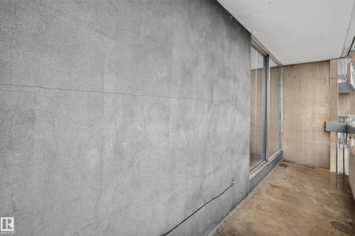 Balcony featuring concrete flooring, sliding glass door, metal railing, and concrete exterior wall - #1508 10883 Saskatchewan Dr Nw Nw, Edmonton, AB - 