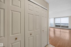 Bifold closet doors with brass-finish knobs providing storage - 
