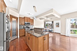 Expansive grassy yard featuring a wood fence perimeter, a wood deck with white railings, and established trees - 