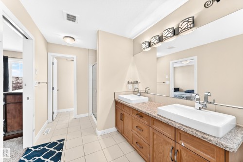 Double vanity featuring rectangular vessel sinks, granite countertops, and wood cabinetry - 2923 16 Street Nw, Edmonton, AB - Indoor Photo Showing Bathroom