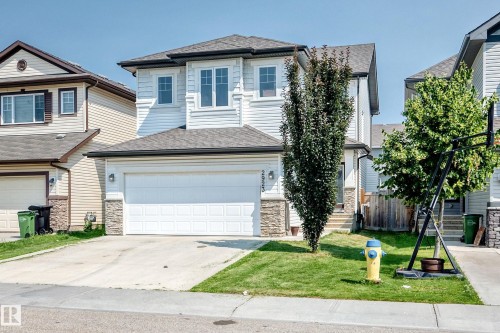 Two-story residence featuring light-colored horizontal siding and stone veneer accents - 2923 16 Street Nw, Edmonton, AB - Outdoor With Facade