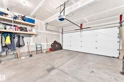 Spacious bedroom featuring neutral wall finishes, carpeting throughout, a ceiling-mounted light fixture, and direct access to a walk-in closet - 